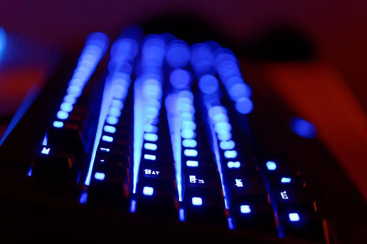 Tastatură de gaming cu iluminare albastră intensă pe un fundal închis